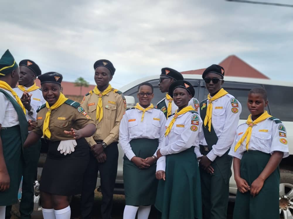 Divine Care Pathfinder Club members posing beside the school vehicle